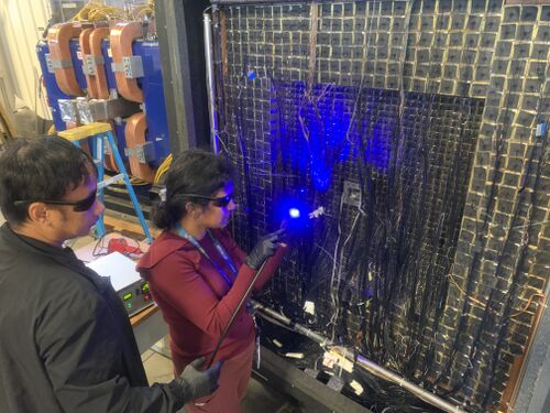 Aruni and Buddhiman applying UV light to set the glue.